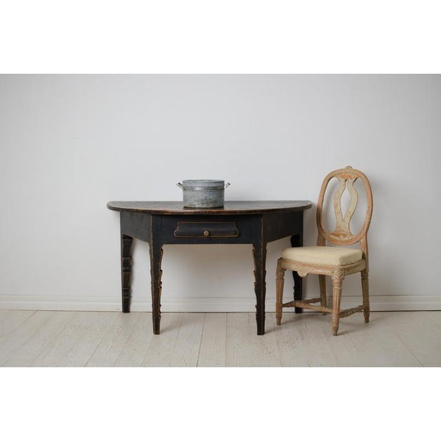 Antique Swedish console table or wall table from the mid 1800s. The table is a Demi lune, shaped like a half circle, and...