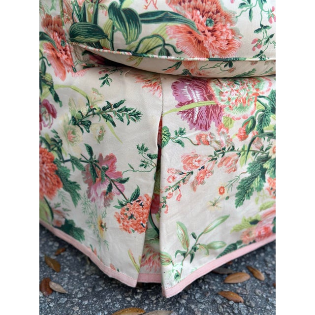 This is a vintage upholstered accent chair featuring a fully skirted base and gently curved back with padded arms. The...