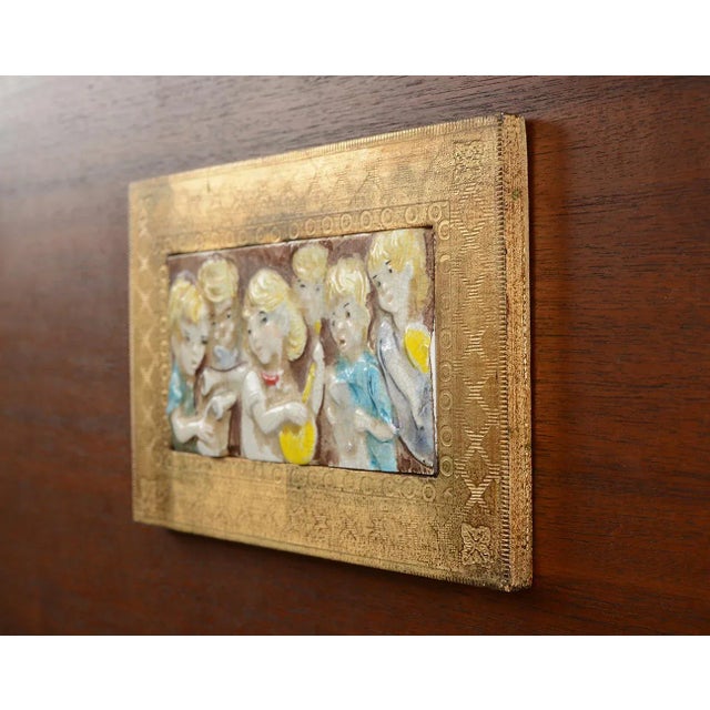 This is an utterly beautiful vintage piece from the 1950s! It's an Italian ceramic bas-relief wall plaque with a wooden...