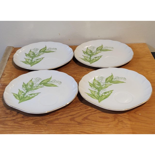 A rare set of four beautiful 8" earthenware pottery plates hand-decorated and glazed in a lily of the valley motif. Each...