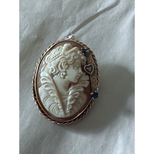 This 1940s 14K gold cameo habillé brooch pendant features a finely carved shell cameo depicting an Edwardian style...