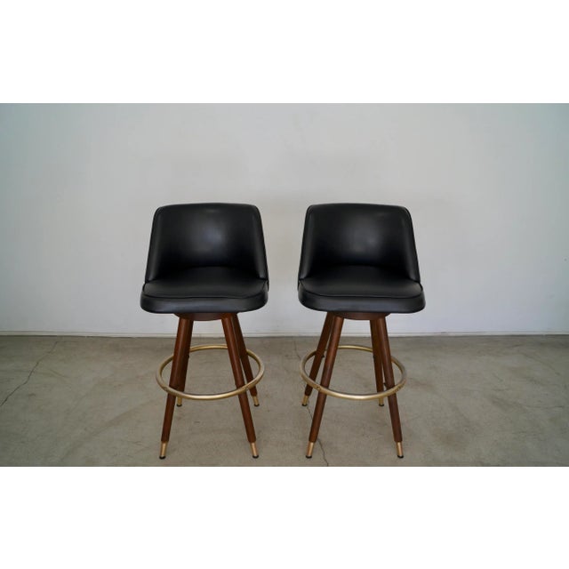 Pair of vintage Mid-century Modern barstools for sale. Original from the 1960's, and in the original black naugahyde faux...