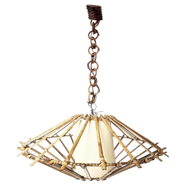 The lampshade is not included ! French rattan chandelier dating from the 1960s. The fixture features an expressive...