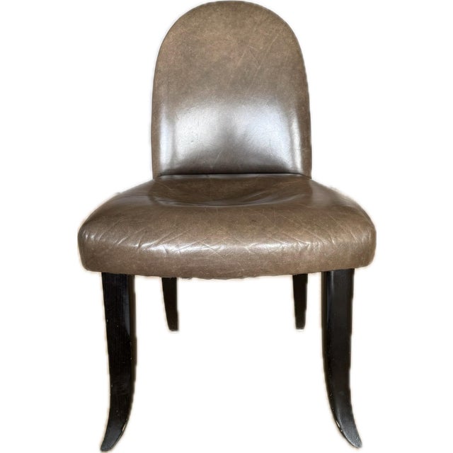 These unmarked vintage Donghia Italian dining chairs feature a refined, sculptural silhouette that reflects the brand’s...