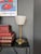 "Senator" lamp in brass with a white opaline tulip shade. Push-button switch on the base. Electrical connection in perfect...
