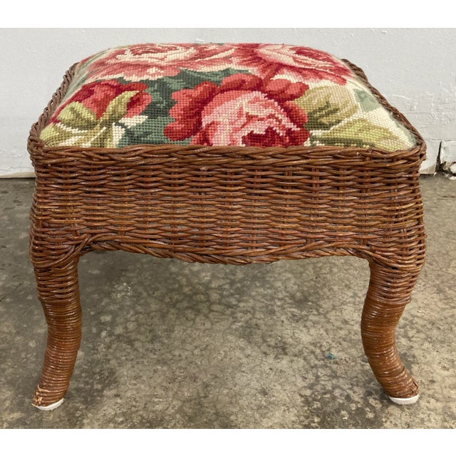 Charming vintage brown wicker stool with a red and pink floral fabric needle point padded top. Vibrant color and timeless...