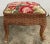 Charming vintage brown wicker stool with a red and pink floral fabric needle point padded top. Vibrant color and timeless...