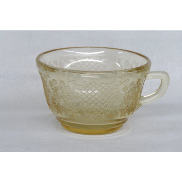 This gorgeous tea cup is made of amber yellow depression glass. We believe the piece to have been made by Federal Glass...