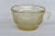 This gorgeous tea cup is made of amber yellow depression glass. We believe the piece to have been made by Federal Glass...