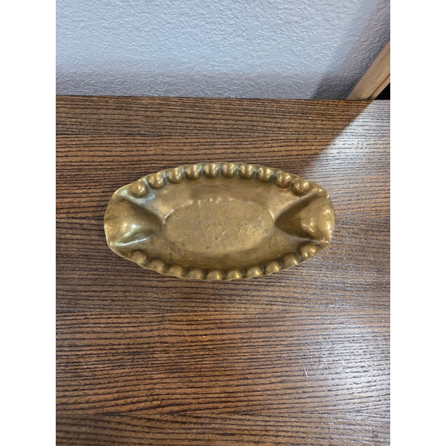 This vintage German brass oval dish, marked “Handarbeit” (handmade), is a charming example of mid-century craftsmanship...