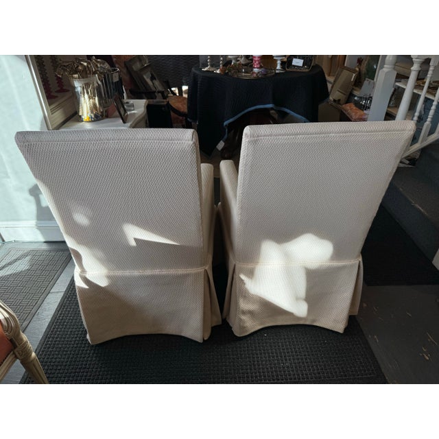 This is a pair of newly reupholstered vintage parsons style chairs. They have an off white designer fabric that is very...