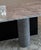 This is a very striking dining table with a dramatic cantilevered solid marble top. It has a cylindrical marble and...