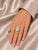 This elegant antique estate cocktail ring is crafted in 14K white gold and showcases numerous brilliant round diamonds...