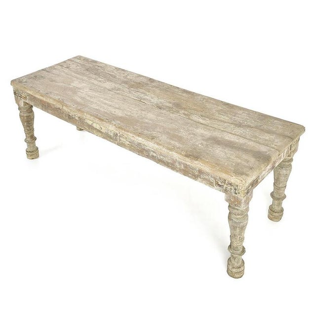 This large wooden coffee table seduces with its simple lines and the delicately worn patina of its top. Its turned legs...