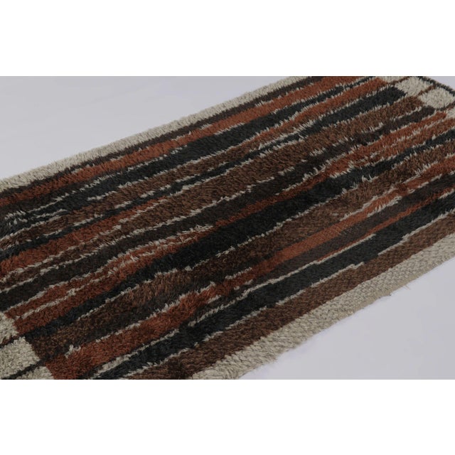 Hand-knotted in high-pile wool in Sweden circa 1960-1970, this 4x7 vintage Swedish Rya runner is a compelling addition to...