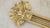 An ornate vintage lacquered brass wall sconce featuring a classical lyre or harp-form backplate with four slender...