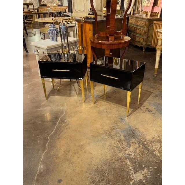 The modern Italian side tables feature a sleek design with a high gloss black lacquered finish, giving them a...