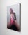 Rupture presents a figure enveloped in soft, blending hues of pink and gray, creating an ethereal atmosphere. The loose...