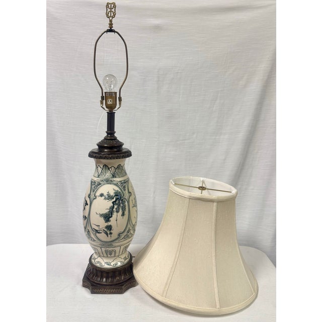 Illuminate your space with this elegant vintage Chinoiserie blue and white ginger jar style table lamp, a stunning piece...