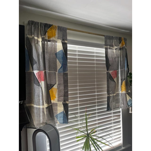 Vintage Marimekko Sine café curtain panels featuring an abstract geometric design of fine black and white grids layered...