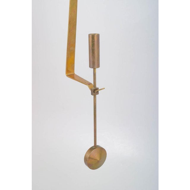 Pierre Forsell for Skultuna, wall hanging pendulum candle holder. Minimalist brass candle holder with pendulum suspension...