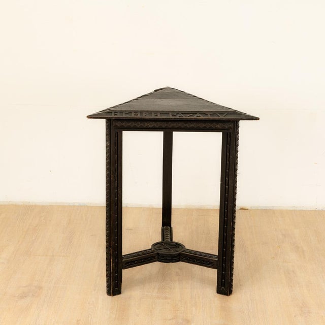 Benjamin Gomez Stained and carved wooden side table – circa 1920–1930 Side table with a triangular top resting on three...