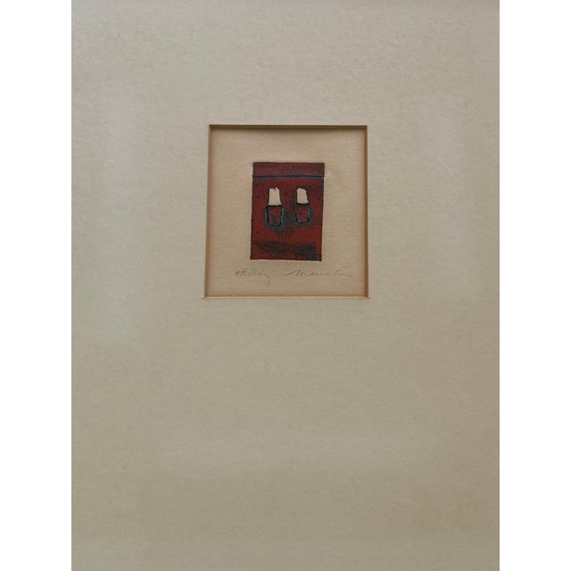 An original signed abstract etching featuring a striking composition of rich crimson and blue with black and a quiet...