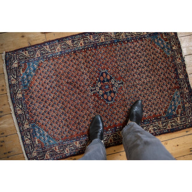 :: Allover covered field of minor botehs in alternating directional rows with a single center medallion bearing an...