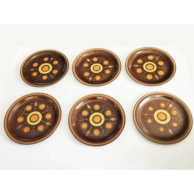 Offered are six dinner plated designed by Georges Briard. This pattern is called "Aztec", and features a sun with rich...