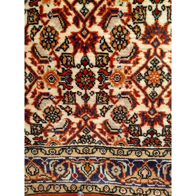 A "near square" size hand-knotted vintage Persian Qum area rug in an all-over Herati pattern circa the mid 1900s. The...