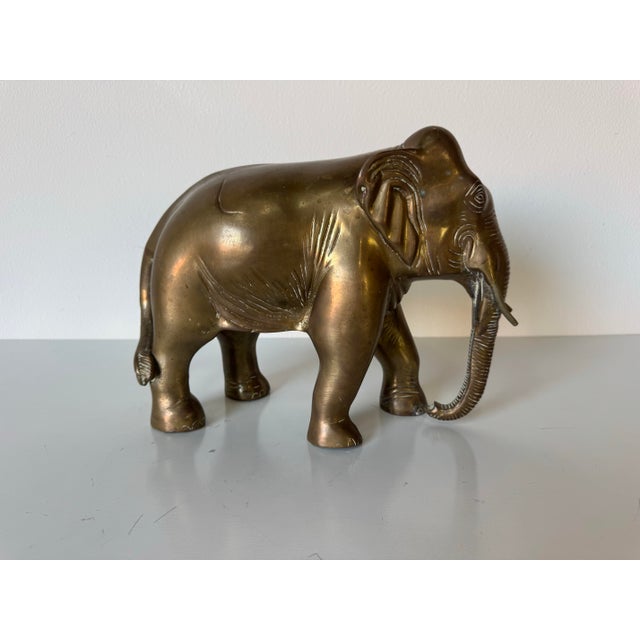 Elegant and timeless, this vintage solid brass elephant sculpture embodies classic craftsmanship and symbolic grace. Hand-...