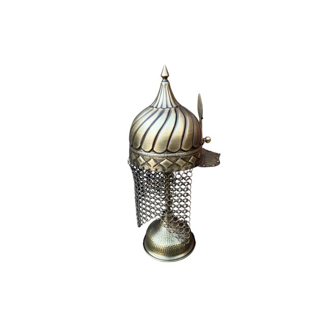 Sweeping, vertical curved flutes across the dome showcase an advanced mastery of repoussé and chasing techniques, creating...