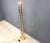 Modernist brass floor lamp featuring integrated white tube lights and an uand a dimmable lamp at the top. The top and tube...