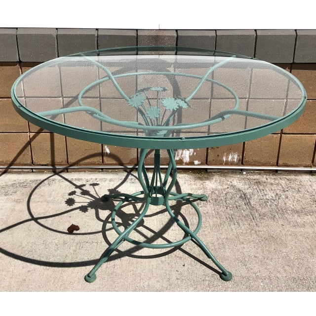 Wonderful large round mid century Woodard & Sons wrought iron daisy pattern patio table. Original glass top and original...