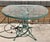 Wonderful large round mid century Woodard & Sons wrought iron daisy pattern patio table. Original glass top and original...