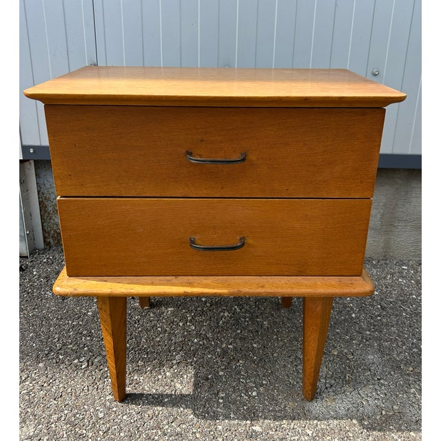 bedside table in light oak, typical of the 1950s, brass handles, splayed legs