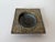 Vintage solid brass ashtray featuring an elegant square form with an ornate floral and scrolling relief pattern...