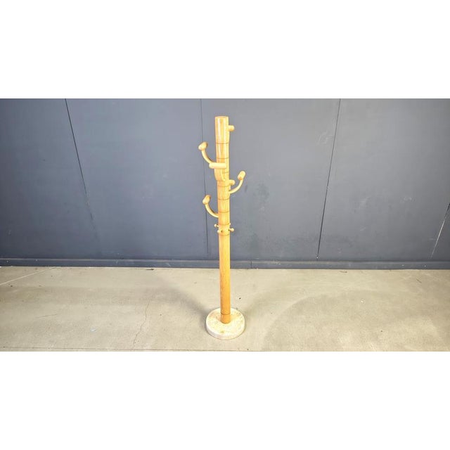 Eye catching coat stand by Ettore Sottsass made from ash wood and a travertine base. Cool timeless and practical design...