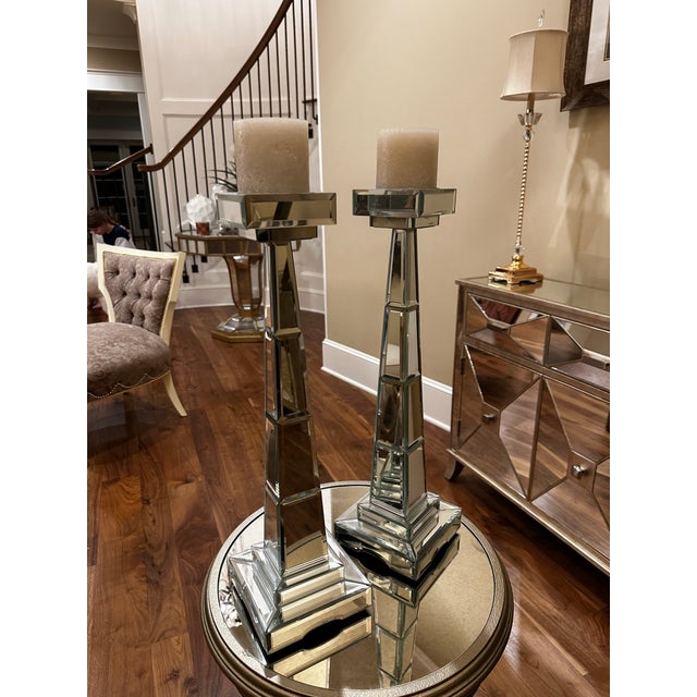 Sleek mirrored candlesticks. Preferably sold as a pair.