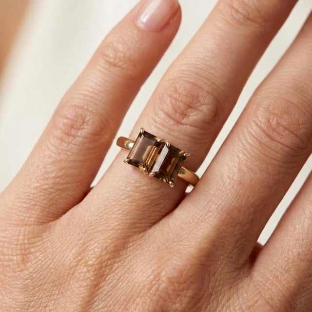 Bold, earthy, and sophisticated, this stunning Toi et Moi ("You and Me") ring pairs two striking, emerald-cut Smoky Quartz...