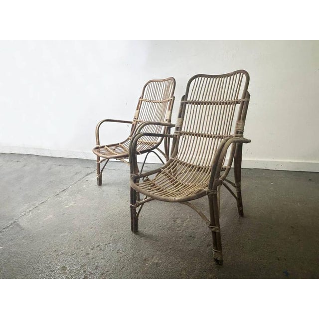 Pair of handmade low-slung Franco Albini-style rattan armchairs, circa 1960s-1970s. Solid bent rattan frame with thin...