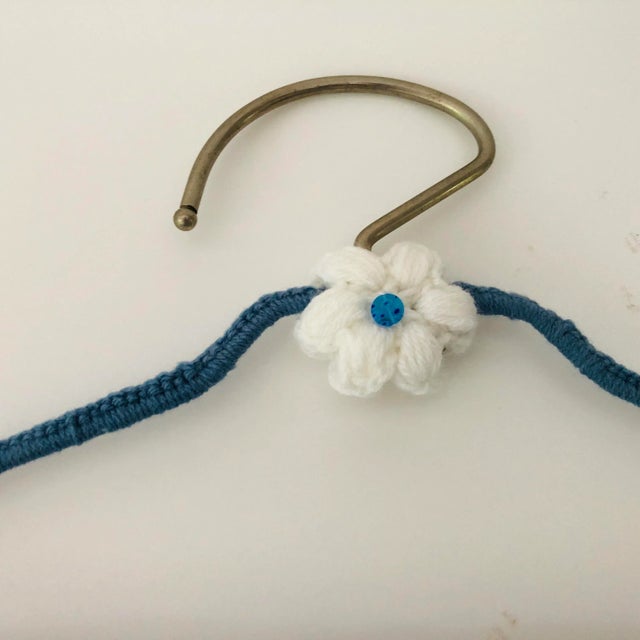Handmade knitting & crochet over a vintage metal clothes hanger decorative flower . 18” L X 9.5” H