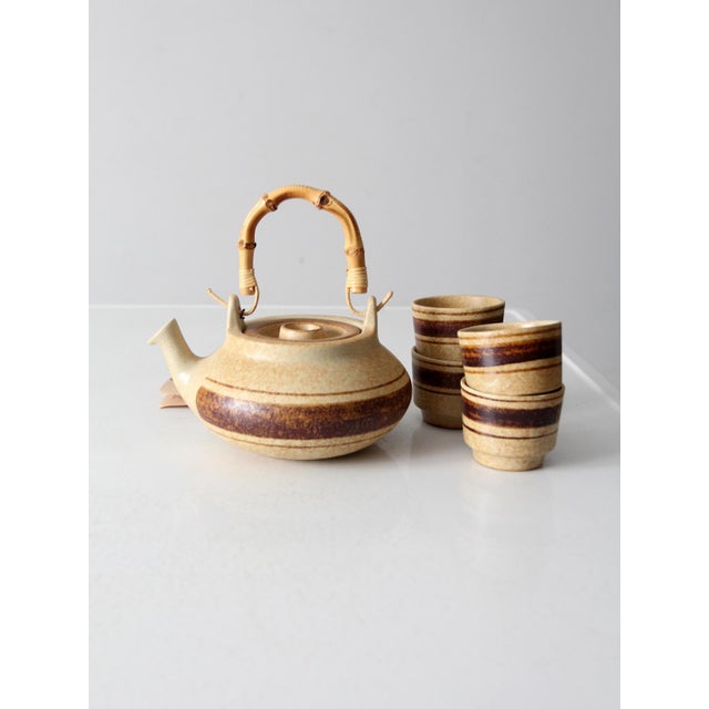 This mid-century tea set from Pottery Craft was designed by Robert Maxwell and includes a teapot with a bamboo handle and...