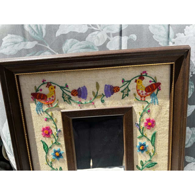 Amazing 1976 vibrant colorful crewel embroidered mirror. Birds, basket of flowers, vine and flowers, buds and leaves....