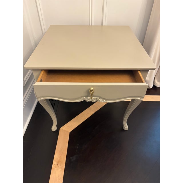 Offered is a solid wood side table by Henredon. This piece features a lovely neutral color and new solid brass bird knob....