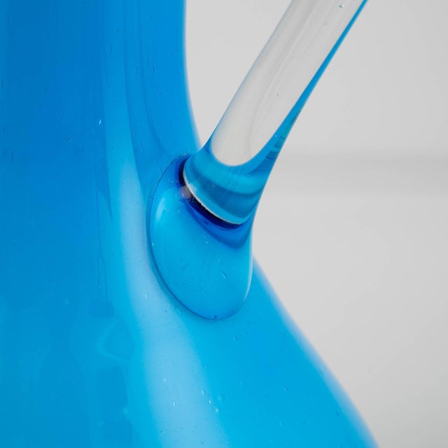 This 20th Century Italian Opaline Medium Blue Glass Jug captivates with its timeless sophistication. The rich, medium blue...