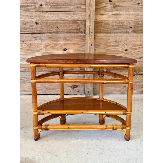An authentic 1940s tropical modernist demilune side table from the highly collectible "Rattanage" line, manufactured by La...