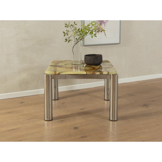 Wonderful side table from the 1960s. High-quality chrome-plated steel frame with an onyx marble table top in cream, brown...