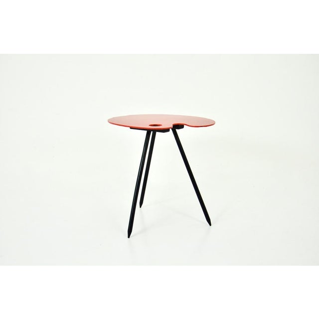 Side table in the shape of a painter's palette by Lucien de Roeck. Wear due to time and the age of the table. This piece...