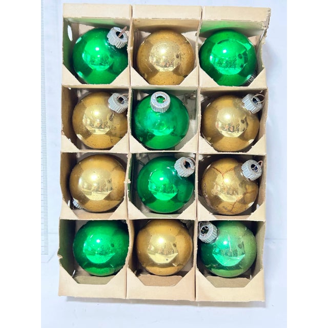 A charming vintage set of classic Shiny Brite glass Christmas ornaments in festive green and gold. These mid-century...